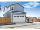 Attached garage with white door and gray siding exterior at 2060 Chambers Rd, Brighton, CO 80601