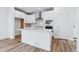 Modern kitchen with white cabinets, stainless steel appliances, and white quartz countertops at 2060 Chambers Rd, Brighton, CO 80601