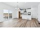 Open concept kitchen and dining area with white cabinets and island at 2060 Chambers Rd, Brighton, CO 80601