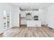 Open concept kitchen and dining area with white cabinets and island at 2060 Chambers Rd, Brighton, CO 80601