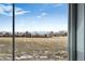 Scenic view of open fields and distant mountains from a window at 2060 Chambers Rd, Brighton, CO 80601