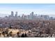 Breathtaking aerial view of the city skyline with tree-lined streets in the foreground at 2635 N Clayton St, Denver, CO 80205