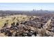 Expansive aerial view of residential neighborhood with a golf course and city skyline at 2635 N Clayton St, Denver, CO 80205