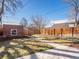 Spacious backyard featuring a brick shed, wooden fence, and walkway at 2635 N Clayton St, Denver, CO 80205