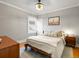 Cozy bedroom featuring a comfortable bed, wood floors, and natural light from a window at 2635 N Clayton St, Denver, CO 80205