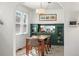 Bright dining room featuring a wooden table, stylish chairs, and a custom built-in hutch with storage at 2635 N Clayton St, Denver, CO 80205