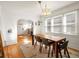 Bright dining room with hardwood floors, a wooden table, and an archway leading to other parts of the home at 2635 N Clayton St, Denver, CO 80205