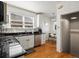 Bright kitchen featuring white cabinets, stainless steel appliances and a breakfast nook at 2635 N Clayton St, Denver, CO 80205