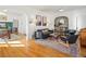 Bright and airy living room featuring hardwood floors, modern furniture, and decorative archways to the adjacent rooms at 2635 N Clayton St, Denver, CO 80205