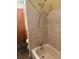 Bathtub in a small bathroom with tiled walls, shower and slate tile flooring at 274 Lincoln Dr, Idaho Springs, CO 80452