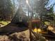 A-frame home nestled in the trees with a deck and stairs, plus off-road vehicle at 274 Lincoln Dr, Idaho Springs, CO 80452