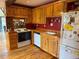 Charming kitchen featuring light wood cabinets, a white range, and a rustic design, perfect for home-cooked meals at 274 Lincoln Dr, Idaho Springs, CO 80452