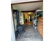 Living room with a wood-burning stove, brick floors, storage shelves, and access to the bedroom at 274 Lincoln Dr, Idaho Springs, CO 80452