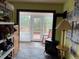 Bright room with wood-burning stove, tile floor and access to outdoor deck at 274 Lincoln Dr, Idaho Springs, CO 80452