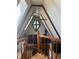 Stairway boasts a vaulted ceiling and views of a window, ceiling fan, and unique diamond window at 274 Lincoln Dr, Idaho Springs, CO 80452