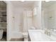 Bright bathroom featuring a shower-tub combination, modern sink, and convenient storage shelves at 5402 Sweet Grass Ct, Castle Rock, CO 80109