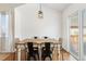 Bright dining area with hardwood floors, contemporary lighting, and a sliding glass door at 5402 Sweet Grass Ct, Castle Rock, CO 80109