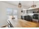 Bright dining area with natural light, stylish light fixtures, and a sliding door to the patio at 5402 Sweet Grass Ct, Castle Rock, CO 80109