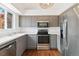 Modern kitchen with stainless steel appliances, gray cabinetry, and bright countertops at 5402 Sweet Grass Ct, Castle Rock, CO 80109