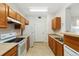 Functional kitchen with white appliances and wood cabinets at 1535 S Florence Way # 407, Aurora, CO 80247