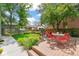 Inviting backyard features lush landscaping, a wood deck and patio furniture perfect for entertaining or relaxing at 2324 S Columbine St, Denver, CO 80210