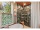 Bathroom featuring an elegant bathtub next to luxurious shower with interesting fixtures and window at 2324 S Columbine St, Denver, CO 80210