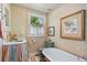 Vintage bathroom with bathtub, patterned wallpaper, and classic fixtures at 2324 S Columbine St, Denver, CO 80210
