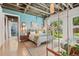 Bright bedroom with concrete floors, modern furnishings, and large glass doors to the yard at 2324 S Columbine St, Denver, CO 80210