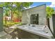 Backyard view of a hot tub with outdoor entertaining space and landscaped yard at 2324 S Columbine St, Denver, CO 80210