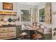 Cozy breakfast nook in kitchen with vintage stove, banquette seating, and floral curtains at 2324 S Columbine St, Denver, CO 80210