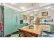 Bright kitchen with green cabinetry, large island with wooden countertop, and modern appliances at 2324 S Columbine St, Denver, CO 80210