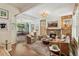 Bright living room with hardwood floors, a decorative fireplace, and an open layout to the dining area at 2324 S Columbine St, Denver, CO 80210
