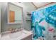 This bathroom has a blue hue and a cute turtle shower curtain at 8260 County Road 39, Fort Lupton, CO 80621