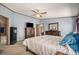 Bright bedroom with a king-size bed, dresser, and access to the bathroom at 8260 County Road 39, Fort Lupton, CO 80621