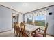 Formal dining room featuring large table with seating for eight and backyard views at 8260 County Road 39, Fort Lupton, CO 80621