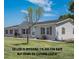 Charming single-story home featuring a well-maintained lawn and classic vinyl siding at 8260 County Road 39, Fort Lupton, CO 80621