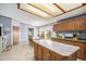 Open kitchen featuring wood cabinets, central island, and tile flooring at 8260 County Road 39, Fort Lupton, CO 80621