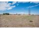 Expansive rural acreage with distant buildings under a bright sky at 8260 County Road 39, Fort Lupton, CO 80621