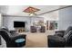 Spacious living room featuring comfortable seating, a modern entertainment center and a unique ceiling fixture at 8260 County Road 39, Fort Lupton, CO 80621