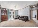 Inviting living room featuring french doors, tiled flooring, neutral carpeting, and an antique wooden hutch at 8260 County Road 39, Fort Lupton, CO 80621