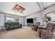 Comfortable living room with plush sofas, large windows, and a decorative ceiling fixture at 8260 County Road 39, Fort Lupton, CO 80621