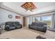 Comfortable living room featuring plush sofas, natural light from a large window, and neutral carpeting at 8260 County Road 39, Fort Lupton, CO 80621