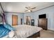 Bright main bedroom with a ceiling fan and ensuite bathroom at 8260 County Road 39, Fort Lupton, CO 80621