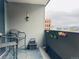 Charming balcony with wicker chairs and colorful flower boxes, perfect for relaxing outdoors at 909 N Logan St # 6D, Denver, CO 80203