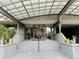 Building entrance with glass doors, canopy and adjacent landscaping at 909 N Logan St # 6D, Denver, CO 80203