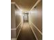 Long hallway with carpet, neutral walls, and classic trim, leading to various rooms at 909 N Logan St # 6D, Denver, CO 80203