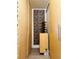 Narrow hallway featuring storage cabinets, unique wallpaper, and wine rack at 909 N Logan St # 6D, Denver, CO 80203