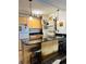 Charming kitchen featuring updated cabinets, granite countertop bar, and attractive lighting at 909 N Logan St # 6D, Denver, CO 80203
