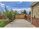 Gated backyard with greenery and direct access to the property's exterior at 3600 Olive St, Denver, CO 80207