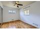 Cozy bedroom with hardwood floors, closet with sliding doors, and natural light at 3600 Olive St, Denver, CO 80207